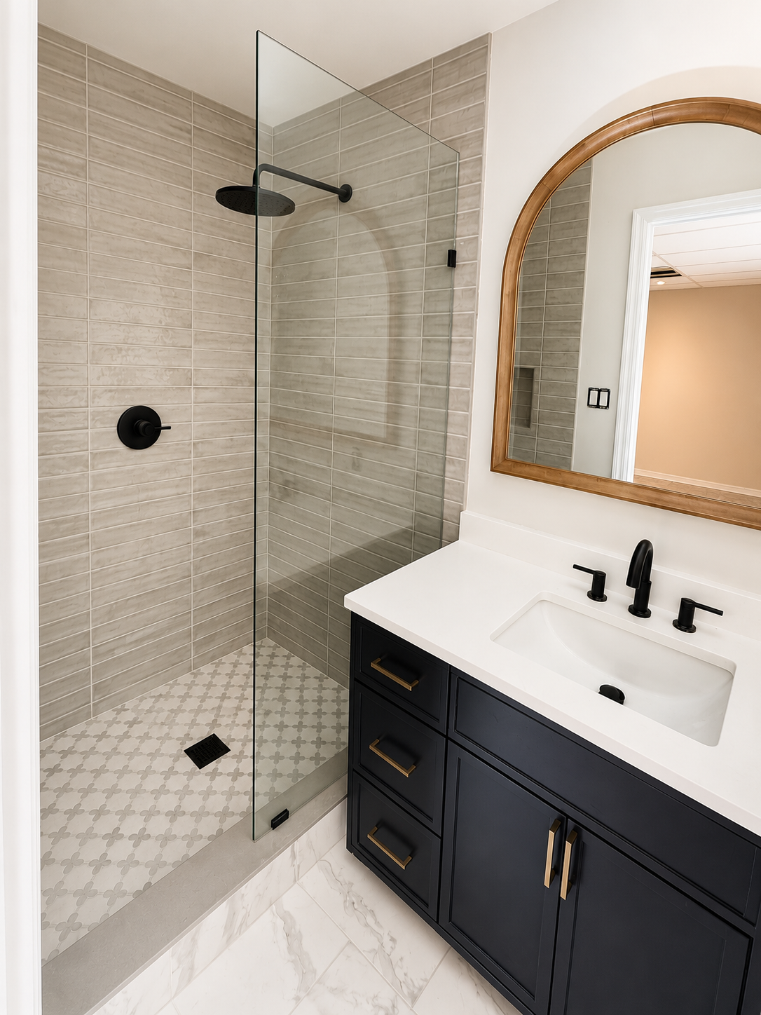Modern remodeled bathroom with walk-in shower and navy vanity